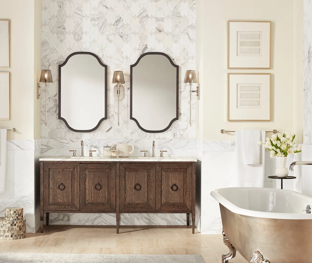 Bathroom with a wood double vanity, paired scalloped mirrors and a freestanding tub