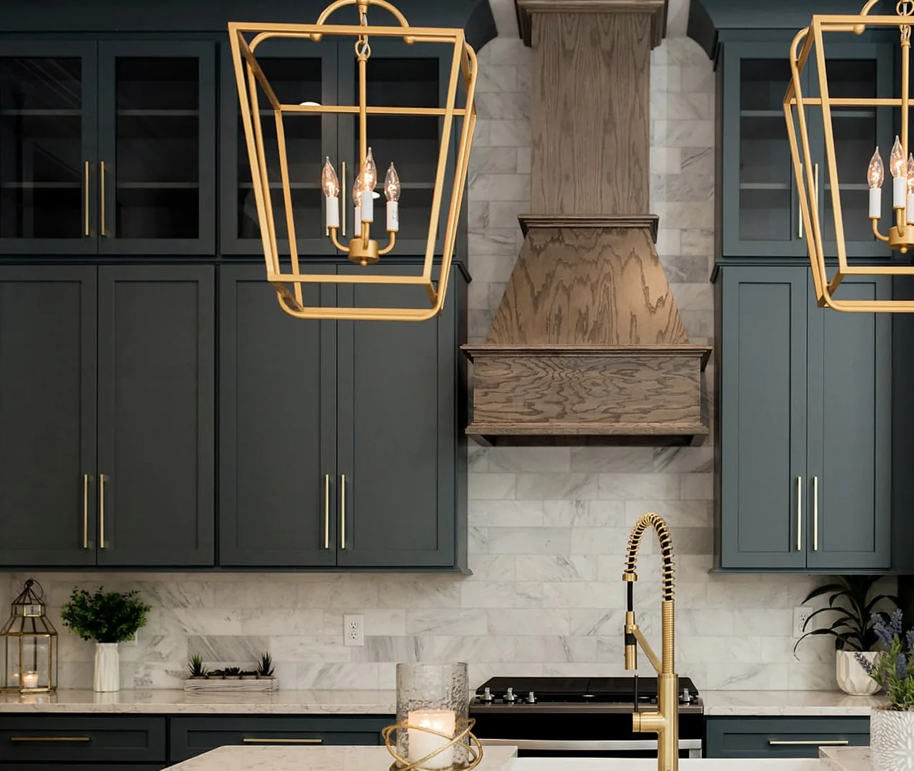 Kitchen cabinetry with a full-height pantry run and a fitted hood