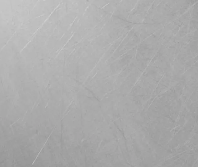Brushed metal surface with a fine directional grain